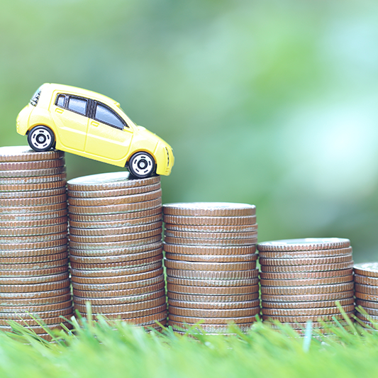 yellow car on top of descending coin stacks